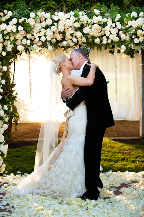 white rose altar - happy couple kissing- ceremony - real wedding photo by Orange County photographers Boutwell Studio